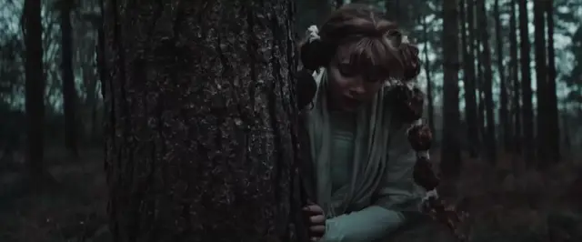 Shin hides behind a tree